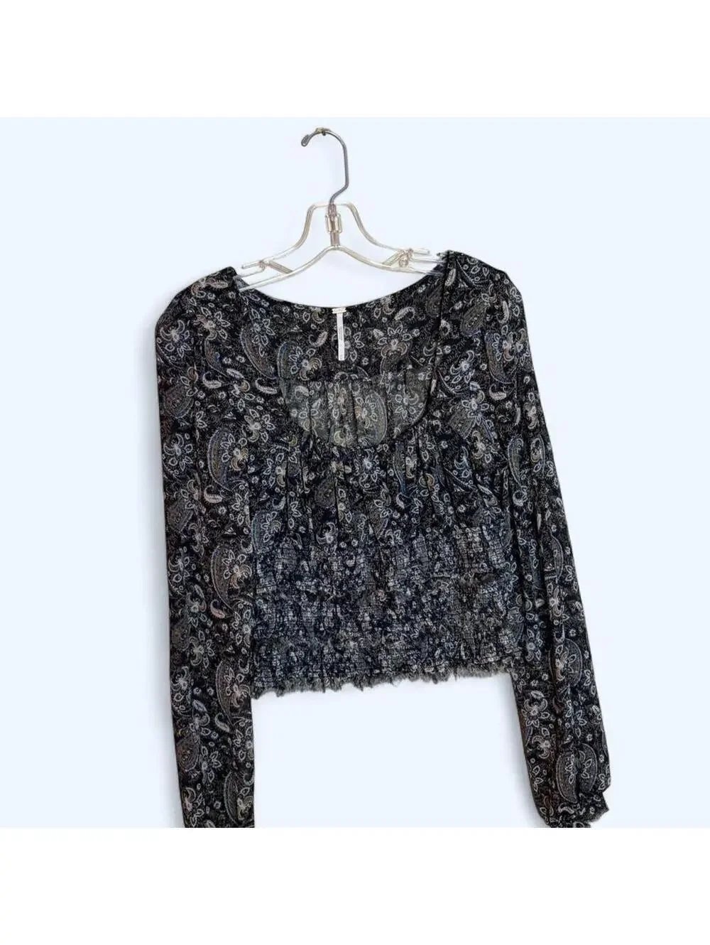 Black and grey paisley print blouse with long sleeves and ruffled hem